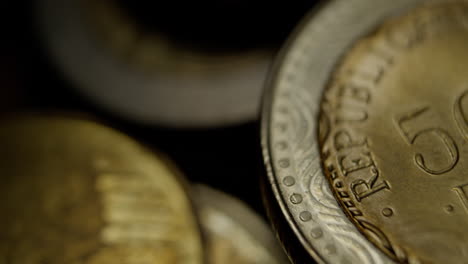 close-up macro view of a mexican 500 pesos coin, showing detailed engravings, texture, and metallic shine under soft lighting