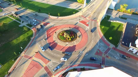 scenic aerial rotation of roundabout, traffic driving in circle