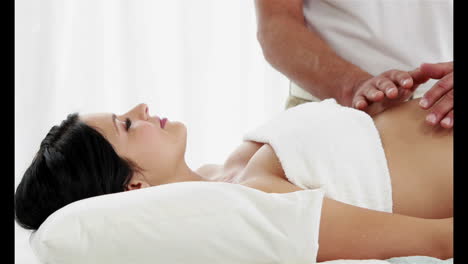 pregnant woman being massaged by a man