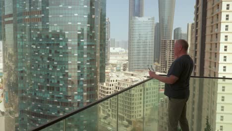 senior man living in a big city on an important mobile smartphone call is frustrated then hangs up to consider the information received - skyscrapers in the background