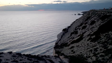dusky seascape along the cyprus coastline, where the cliffside road hugs the rugged terrain overlooking the calm mediterranean sea at twilight