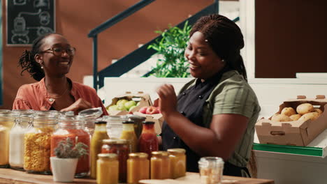 merchant offering food sample to customer at farmers market