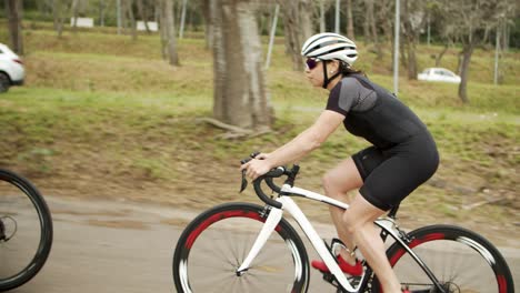 athletic man and women riding bicycles on the road