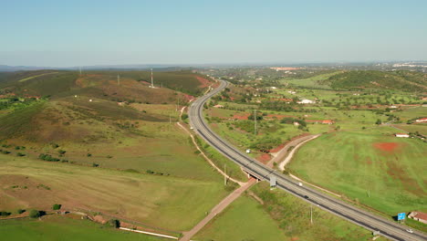 Aerial:-A-highway-going-through-the-country-side-of-the-Algarve-in-Portugal