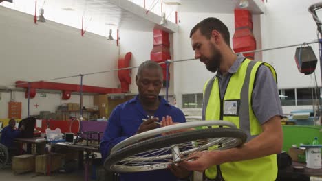 workers discussing about a wheel