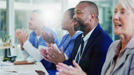 medical professionals applaud during a meeting