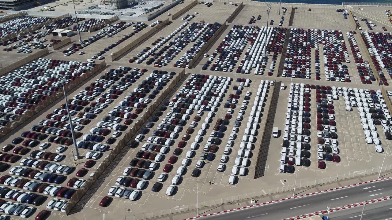 Impressive drone footage showcasing the vast scale of Morocco's automotive export sector. Features organized rows of thousands of new vehicles at a world-class industrial logistics hub