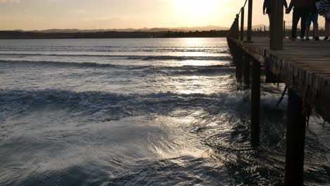 family walking on a pier at sunset