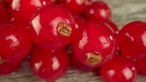 Super-close-macro-of-a-redcurrants-on-a-wooden-table.