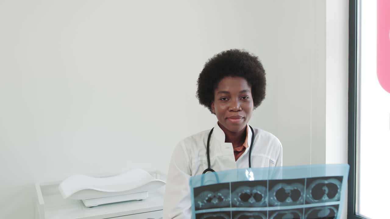 Female africanamerican doctor examines xray of lungs in clinic doctor examines xray of lungs of a