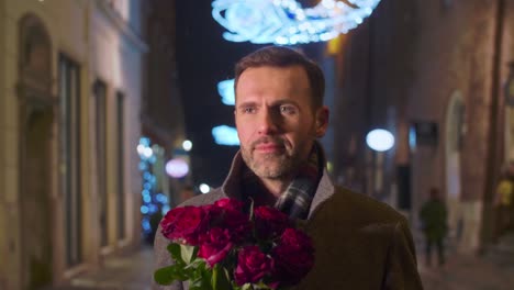 man with a bunch of roses going down the street