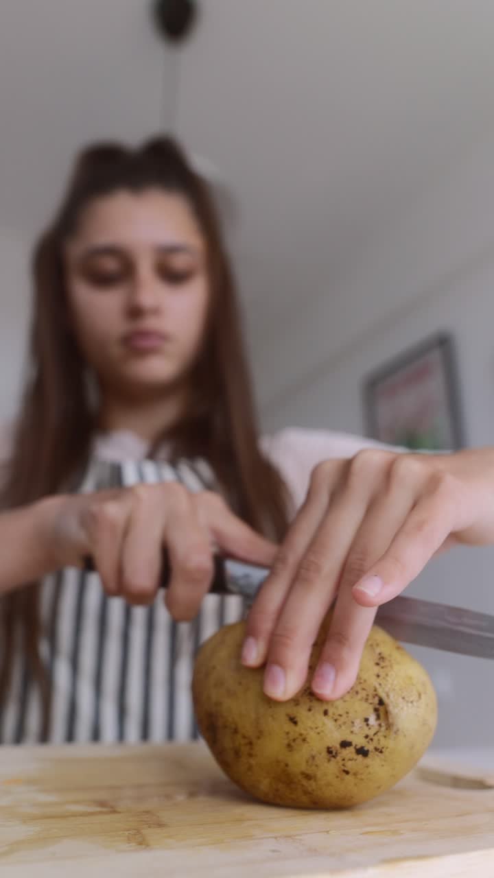 Young woman preparing a potato