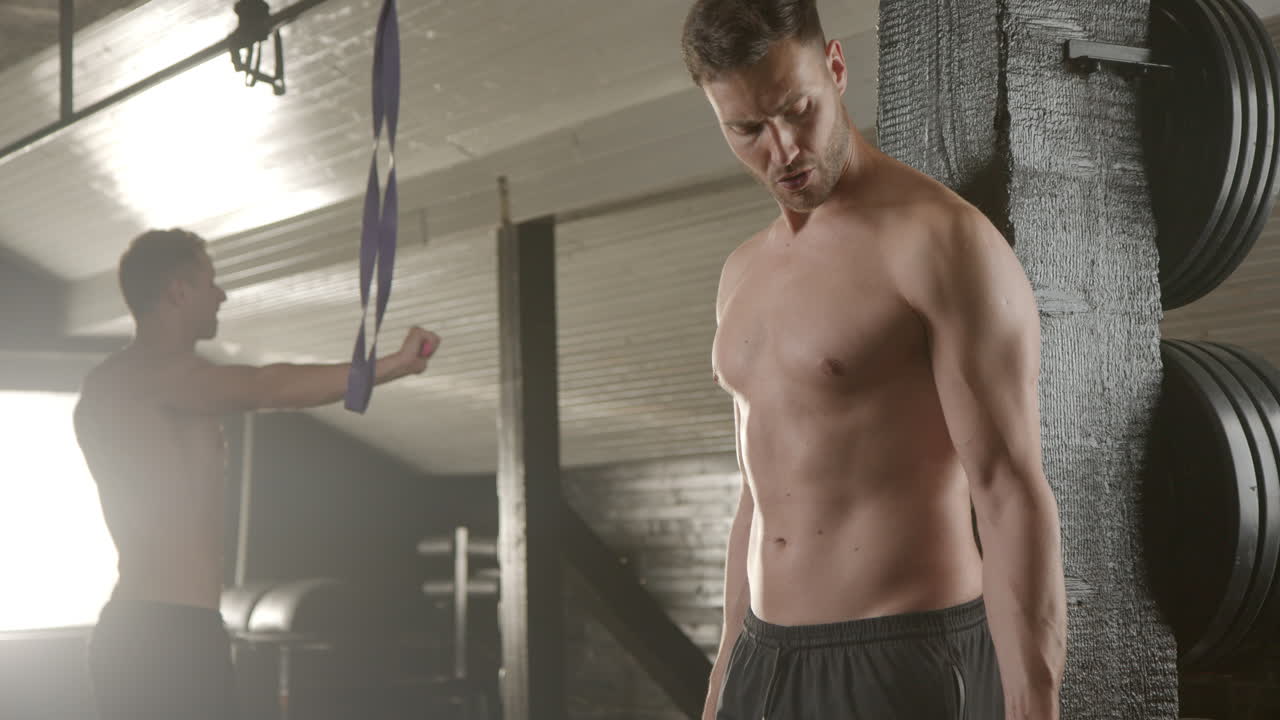 Man lifting dumbbell in gym