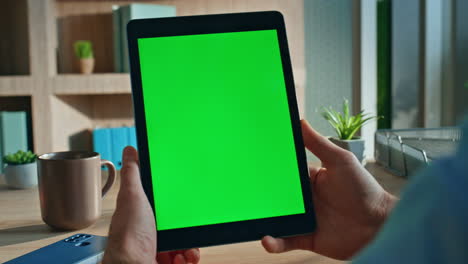 startuper hands holding mockup tablet watching webinar at modern office close up