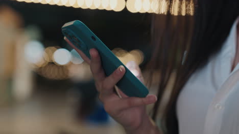 woman using a phone outdoors at night
