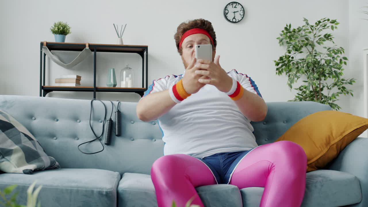 Funny friends taking selfies on couch