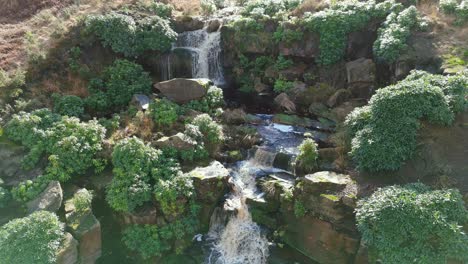 Aerial-drone-footage-of-a-tall-rocky-waterfall-in-the-Yorkshire-Dales,-Pennies