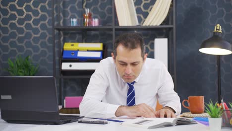 Businessman-looking-for-documents-at-the-table.