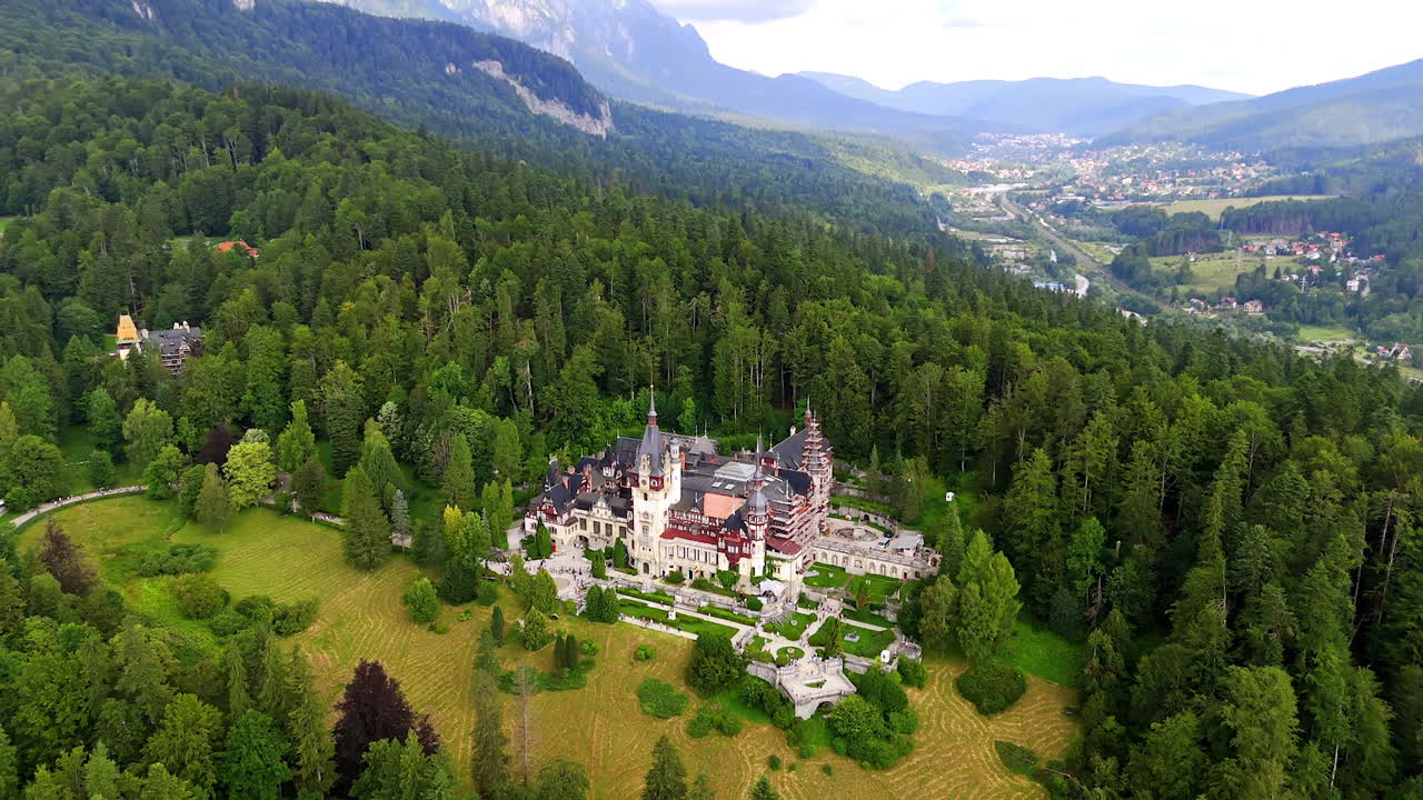 Distancing from the beautiful territory of the Pele? Castle in the Carpathian Mountains, Romania. Residential area in the mountain valley at backdrop