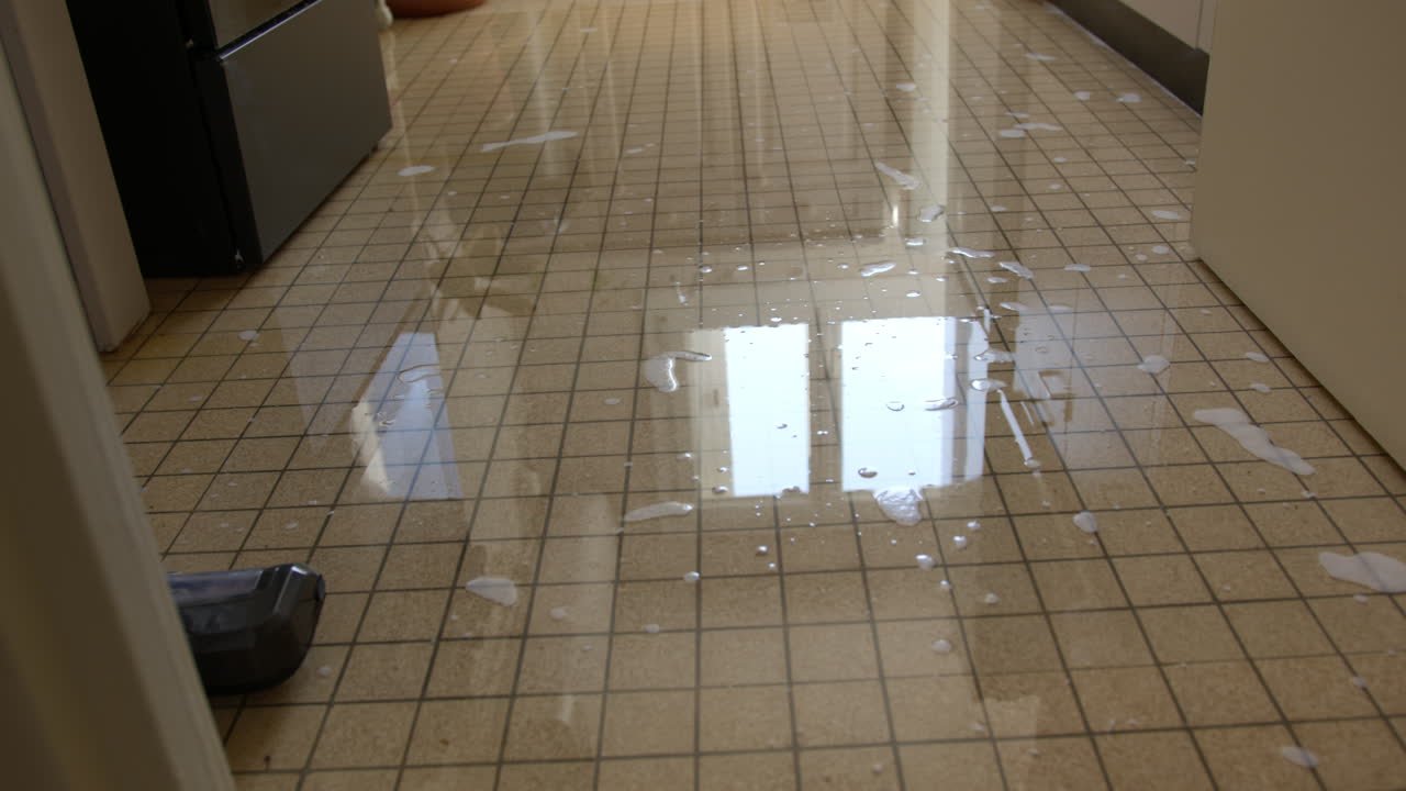 Water And Soap Scattered Across A Tiled Floor - Slippery Tiled Floor With Soap. - closeup shot