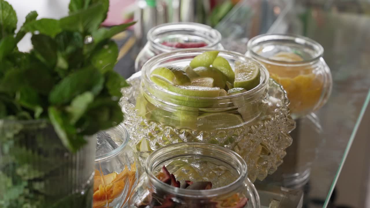 jars of lime mint passion fruit and peels arranged for cocktail preparation