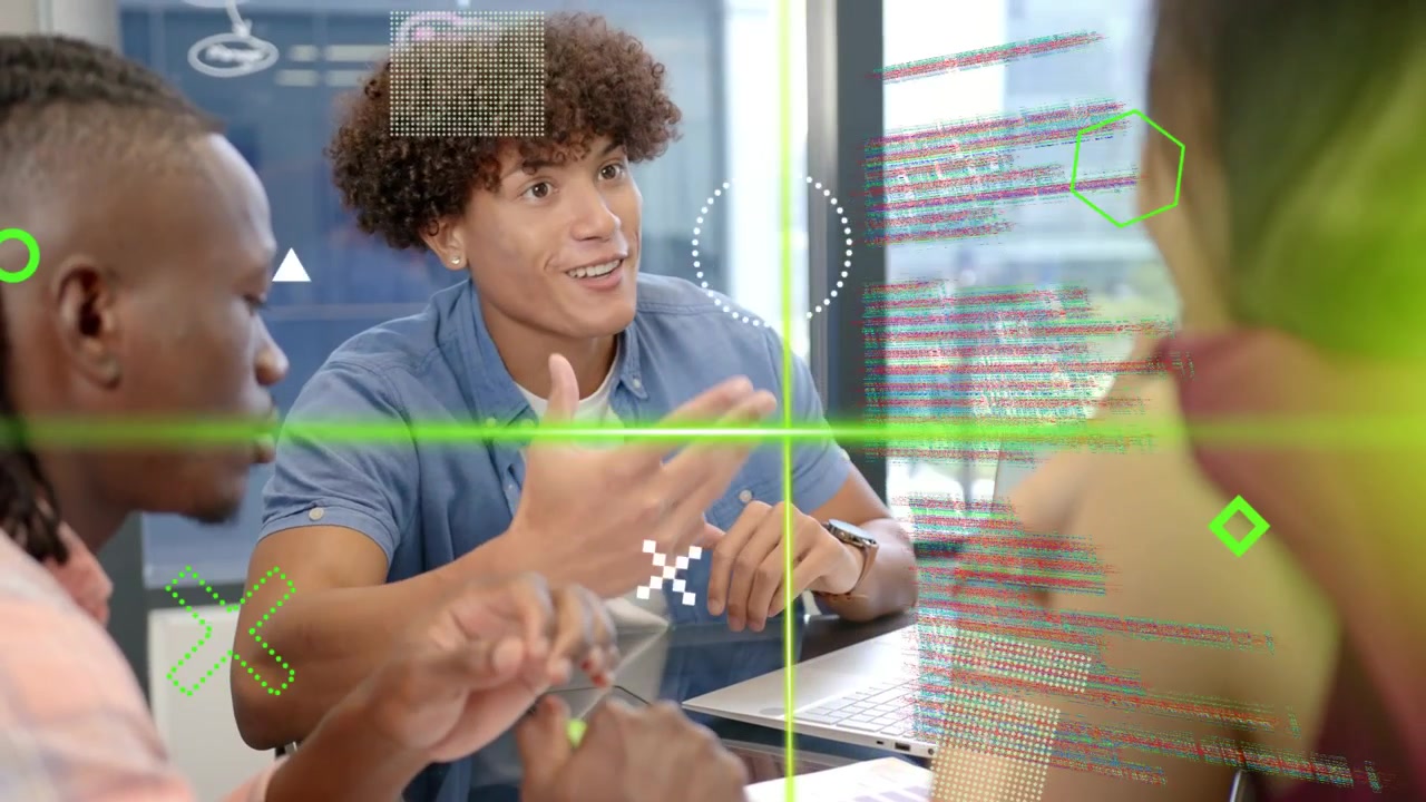 Center male leading tech meeting gesturing and smiling causing green overlay over laptop for review