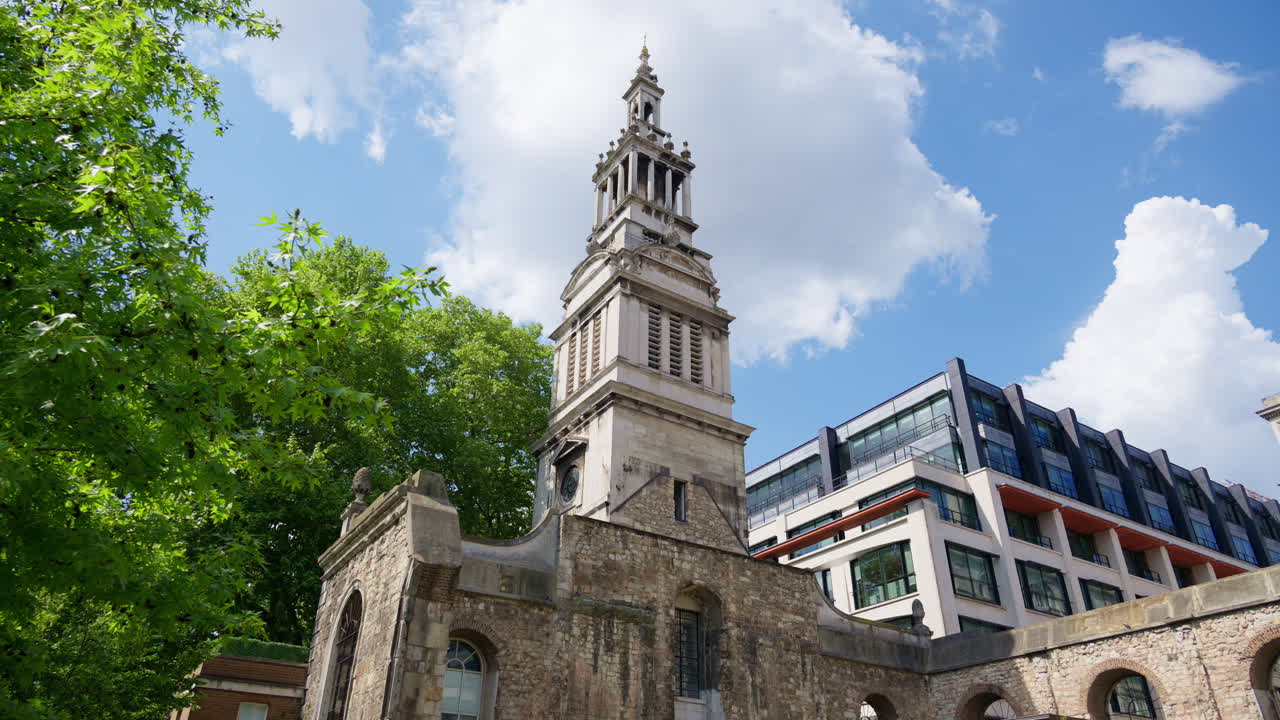 Christchurch Greyfriars Church Garden and modern buildings in central London under a blue sky. United Kingdom