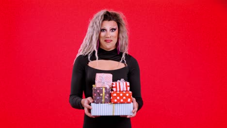 drag queen holding a stack of colorful wrapped gifts