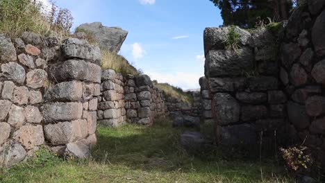 scrutinizing the regal view of cusilluchayoc el templo de los monos in cusco district, peru - aerial pan left