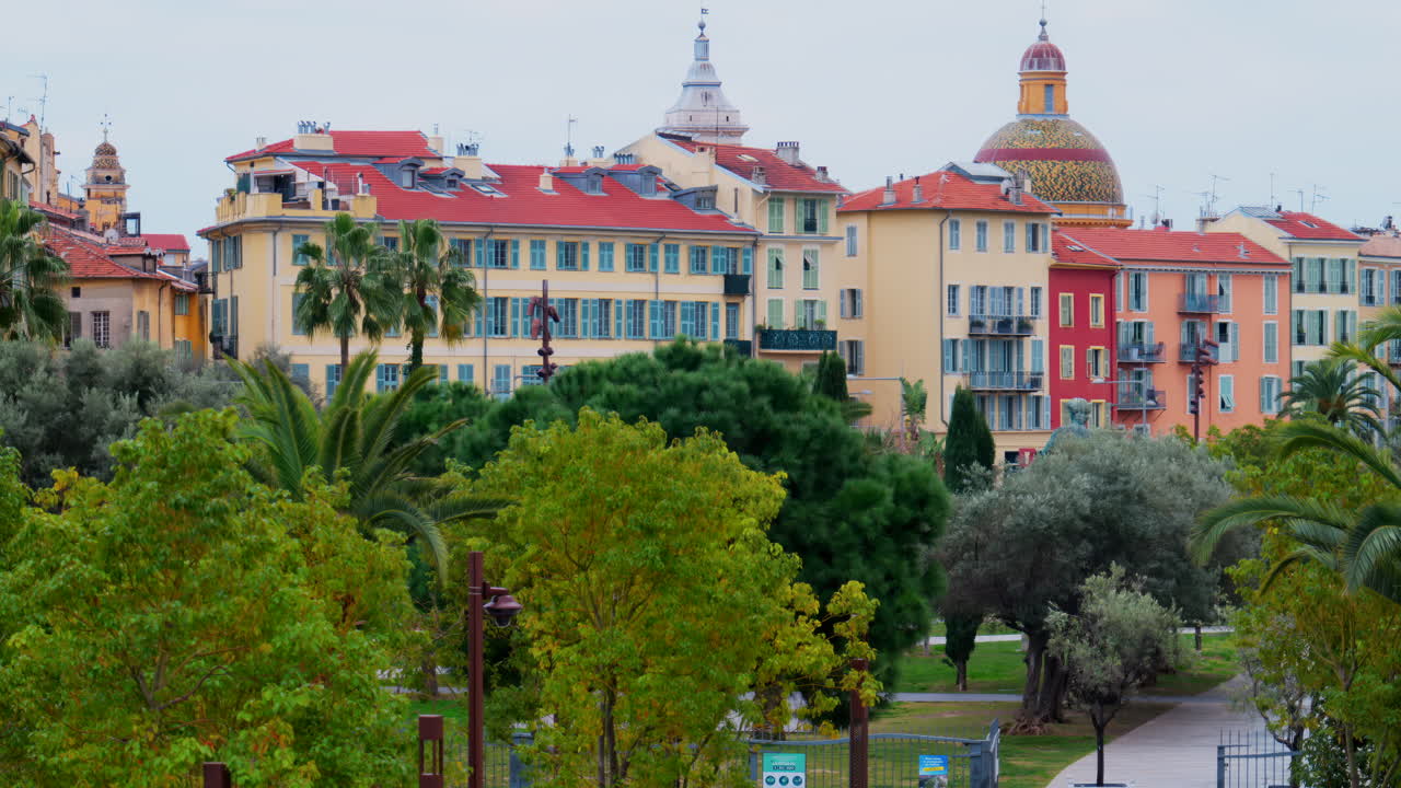 Colourful buildings and trees in the skyline of Nice, France on a cloudy day