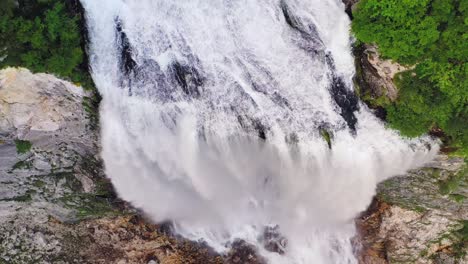 Boka-waterfall,-majestic-stream-come-to-light-on-rocky-shelf,-Triglav