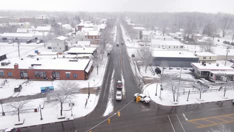 Main-street-and-intersection-small-American-town-in-winter-season,-aerial-view