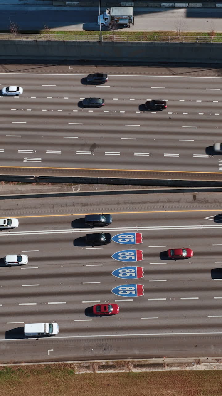 Aerial view of vehicles driving along Interstates 85 downtown Atlanta USA. Vertical video