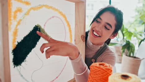 woman creating needlepoint art