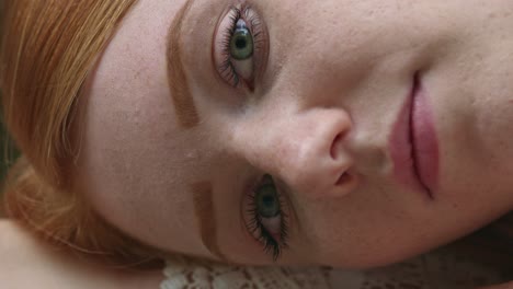 close-up highly-detailed portrait of amazing young redhead female model with green eyes and clean healthy skin with lots of freckles, looking at camera