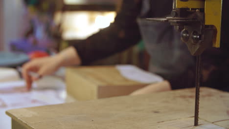 worker in bespoke shoemakers drawing template for last