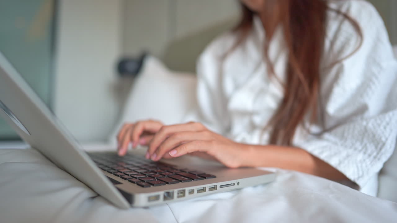 Hand of unrecognizable woman typing on laptop keyboard