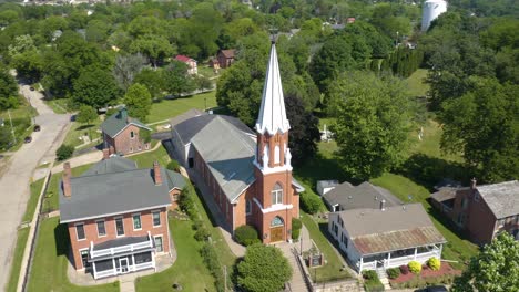 aerial orbiting shot above beautiful traditional christian church small town usa