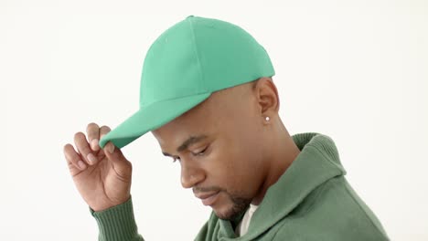 african american man wearing green peaked cap with copy space on white background