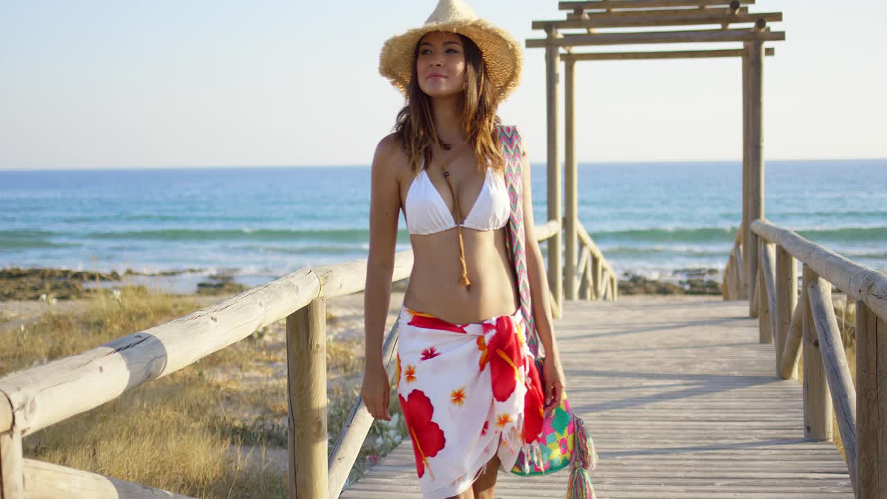 Mujer sonriente en un paseo marítimo de madera