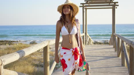 Smiling-woman-on-a-wooden-beachfront-promenade