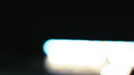 blurred city lights out the window while driving in a car