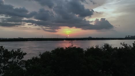 Aerial-view-of-the-Mississippi-River,-Tug-boat-and-sunset