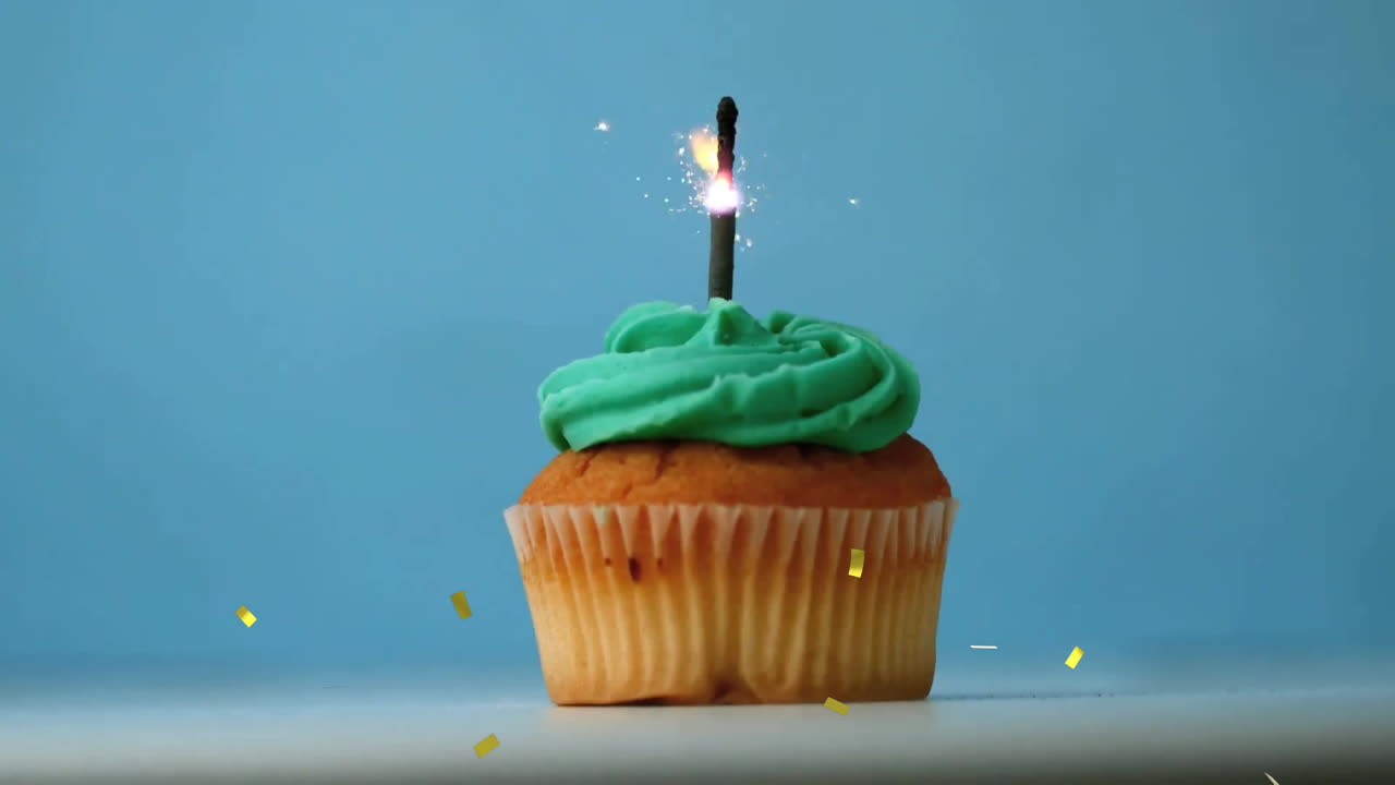 Green frosting cupcake with lit candle, surrounded by falling confetti animation