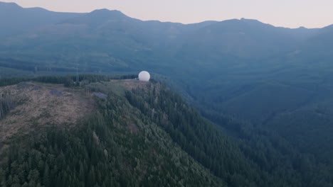 Wide-aerial-footage-of-a-globe-radio-station-on-top-of-a-mountain-in-the-Cascade-Mountains