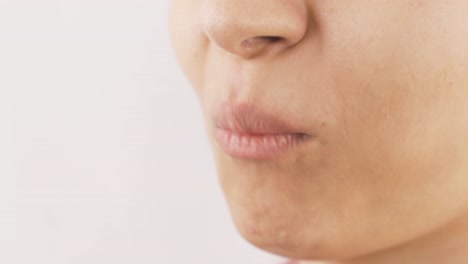 close-up portrait of woman eating turkish delight.