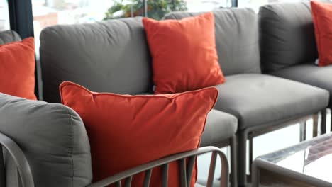 outdoor patio furniture with orange throw pillows