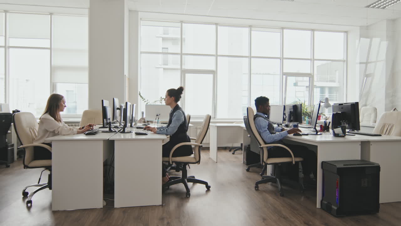 Businessman in Wheelchair Riding Through Office