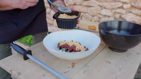 Chef-prepares-Mediterranean-food-with-raw-tuna-and-crushed-almonds