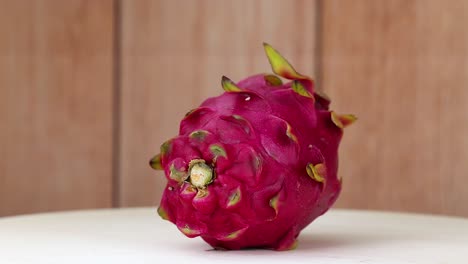 dragon fruit rotates on a wooden surface